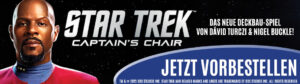 Banner für ein neues Star Trek Deckbau-Spiel mit dem Titel "Captain's Chair". Links ist eine Person in roter Uniform abgebildet, rechts steht: "Das neue Deckbau-Spiel von Dávid Turczi & Nigel Buckle!" Im Vordergrund befindet sich ein blauer Button mit der Aufschrift "Jetzt vorbestellen". Der Hintergrund ist schwarz mit Sternen.
